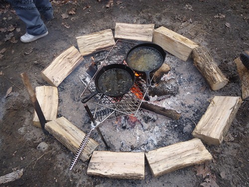 Deer Camp cleaning the pans over a fire